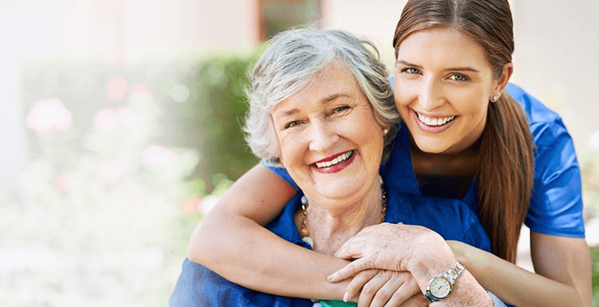 Caregiver and client in a warm, supportive home setting