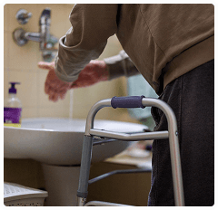 Caregiver gently supporting a client, conveying care and dignity