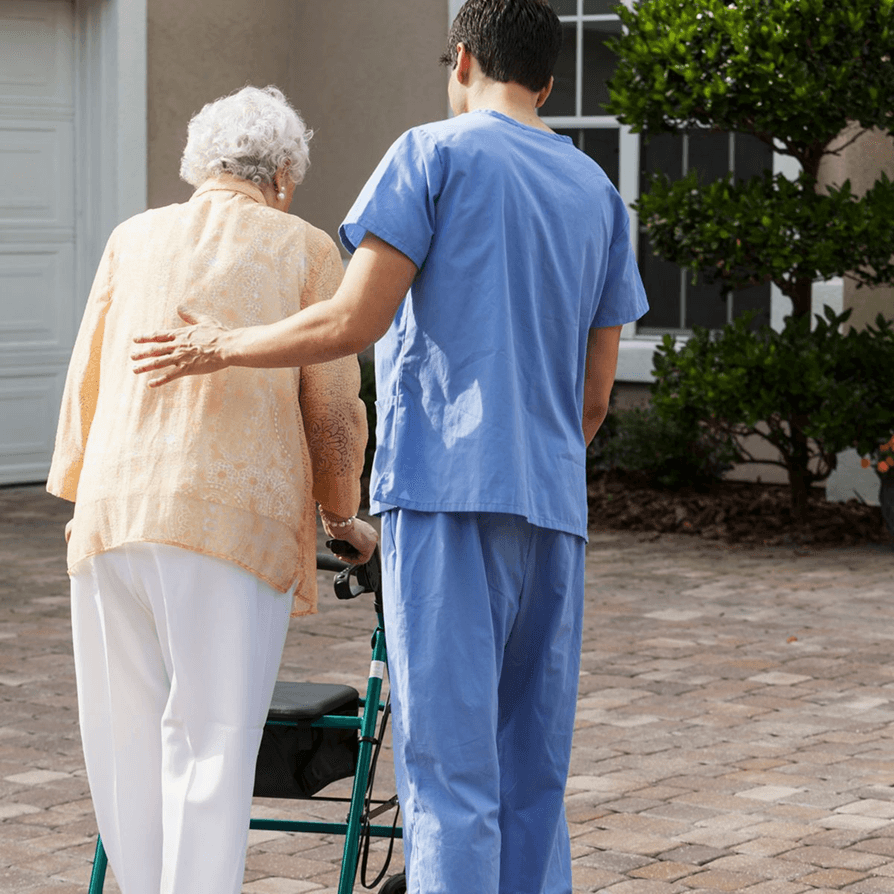 Caregiver's hand gently holding an older person's hands, conveying care and support