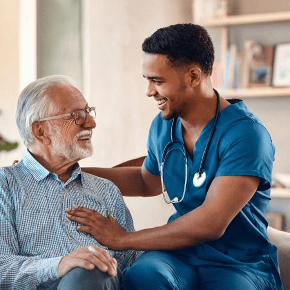 Elderly woman in a yellow top doing light arm stretches while seated in a chair