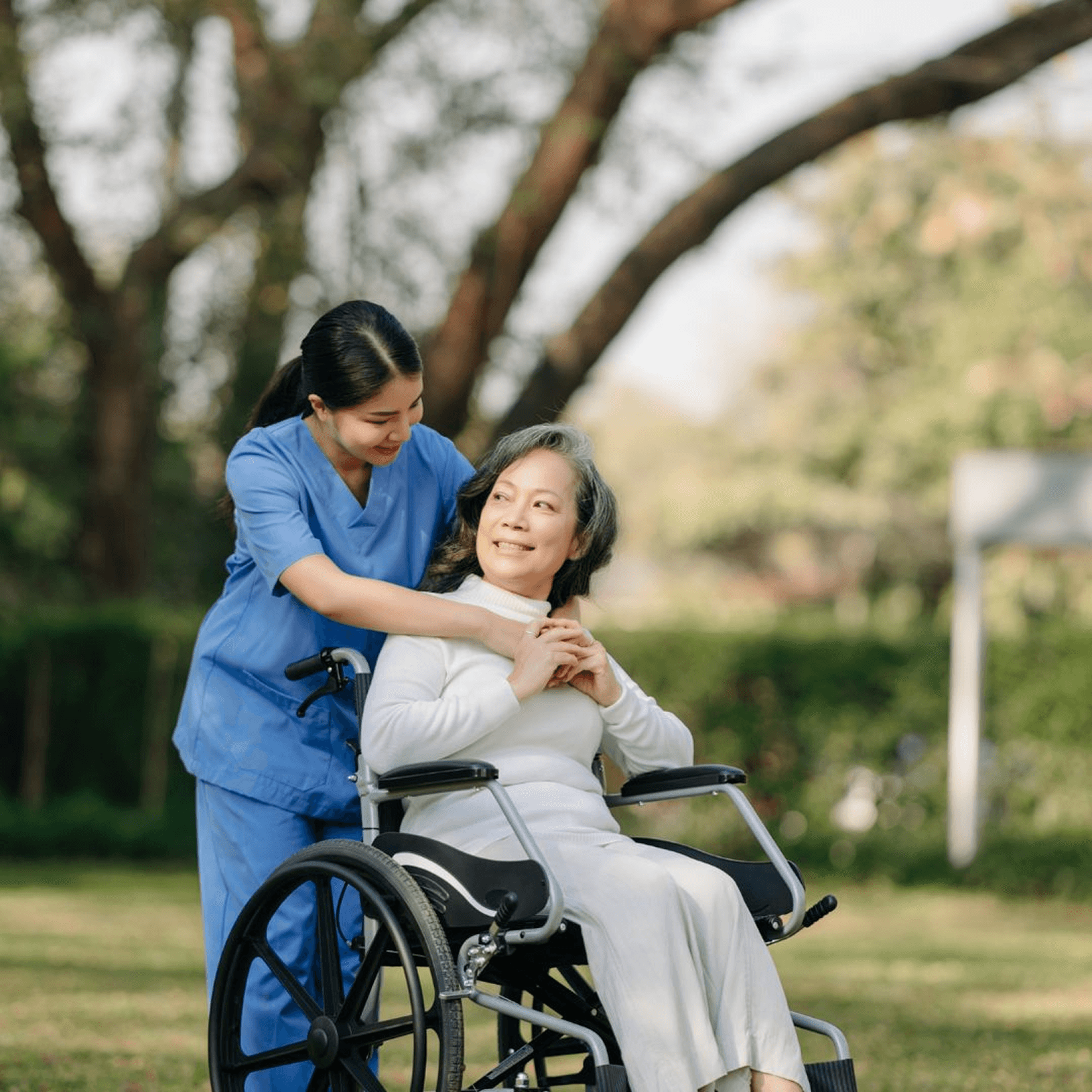 Younger person's hands gently holding an older person's hands, conveying care and connection